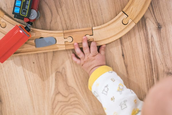 a hand on a wooden floor