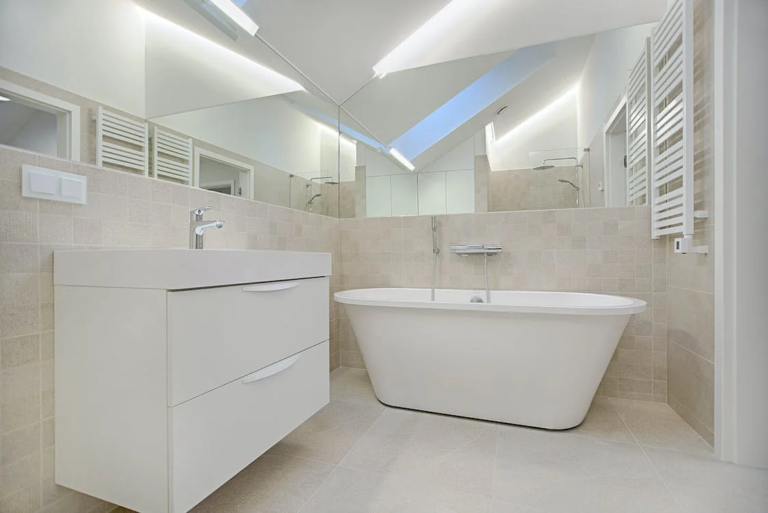 A spacious bathroom with a white tub and sink