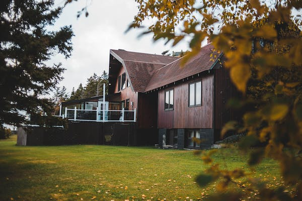 a wooden house with a garden